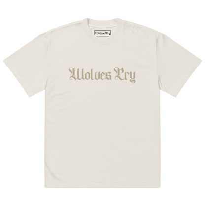 Front view of Wolves Cry Oversized Vintage Wash Tee in bone with off-white camo spell-out logo — neutral streetwear staple with a lived-in finish.