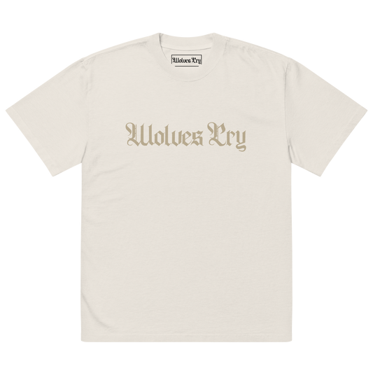 Front view of Wolves Cry Oversized Vintage Wash Tee in bone with off-white camo spell-out logo — neutral streetwear staple with a lived-in finish.
