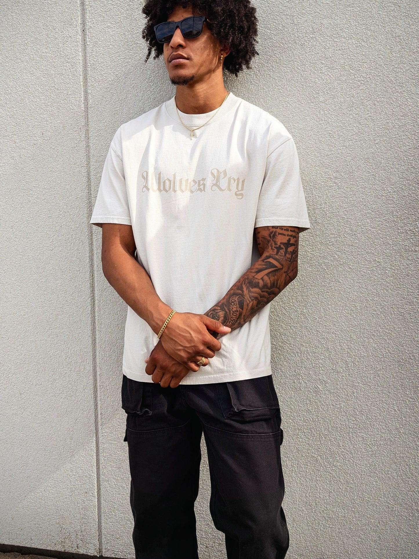 Model wearing Wolves Cry Oversized Bone Vintage Tee with off-white camo lettering — relaxed drape, heavyweight feel, everyday minimal street look.