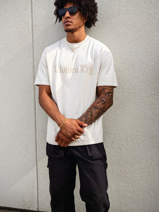 Model wearing Wolves Cry Oversized Bone Vintage Tee with off-white camo lettering — relaxed drape, heavyweight feel, everyday minimal street look.
