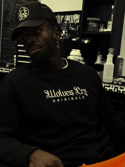 Model wearing the Wolves Cry Originals Plain Jane Crew in a barbershop setting, styled with a trucker cap and relaxed fit.