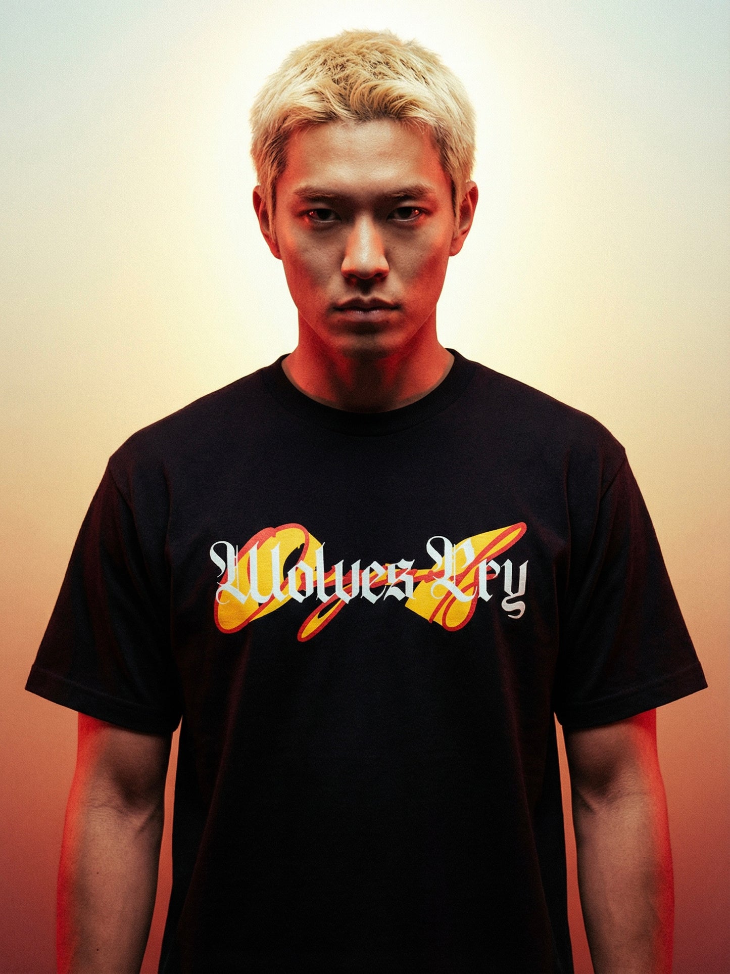 Person wearing a black t-shirt with wolves cry originals logo and text on a gradient background
