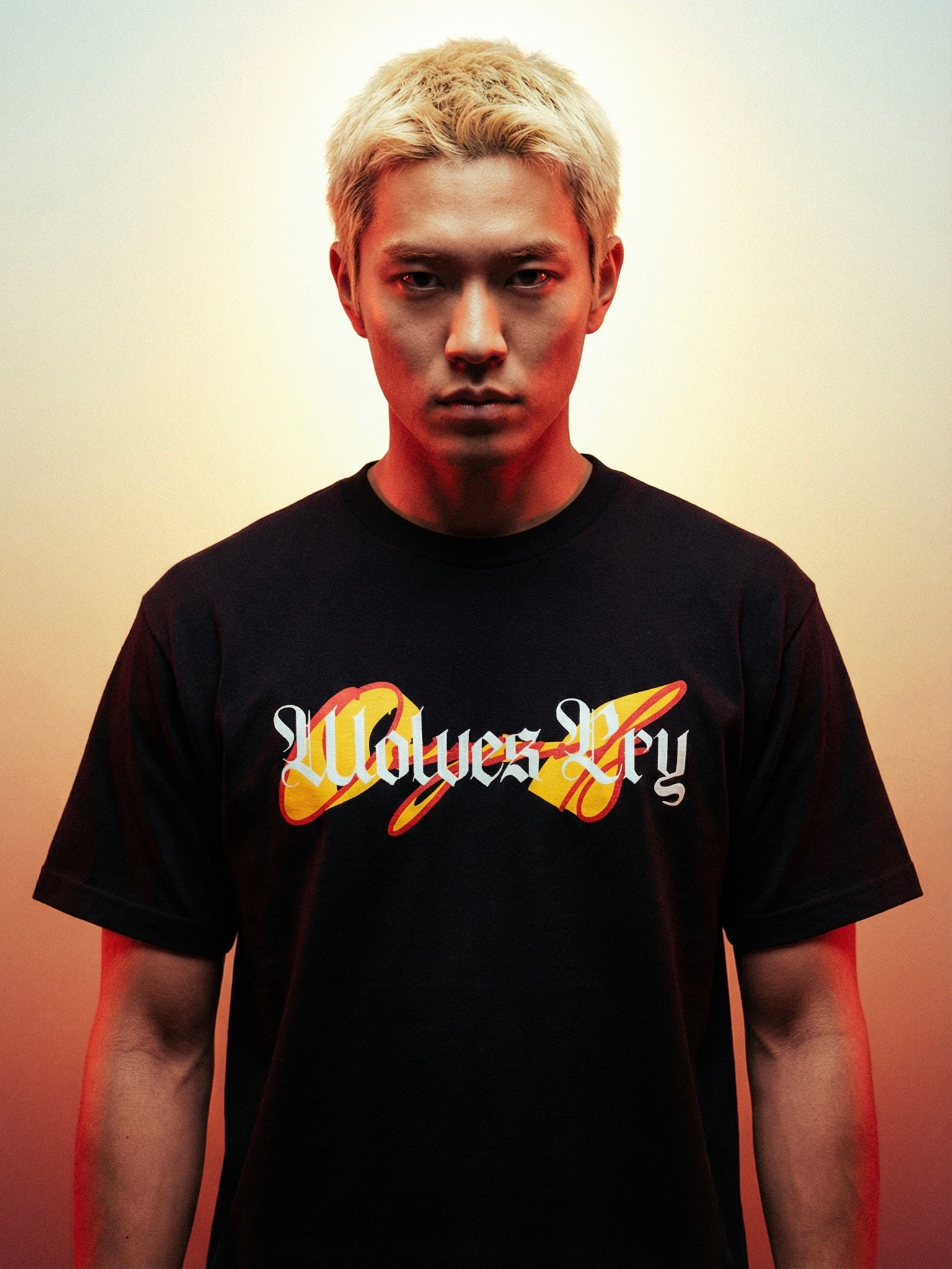 Person wearing a black t-shirt with wolves cry originals logo and text on a gradient background