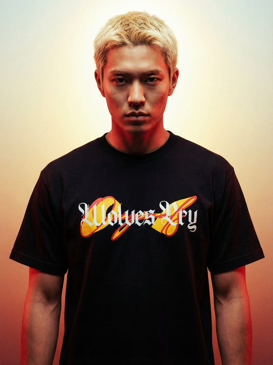 Person wearing a black t-shirt with wolves cry originals logo and text on a gradient background